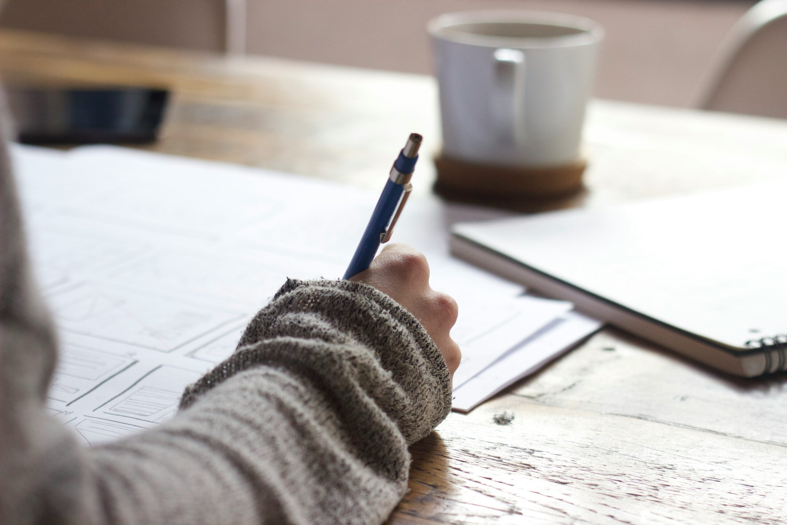 Write on paper using pen with tea